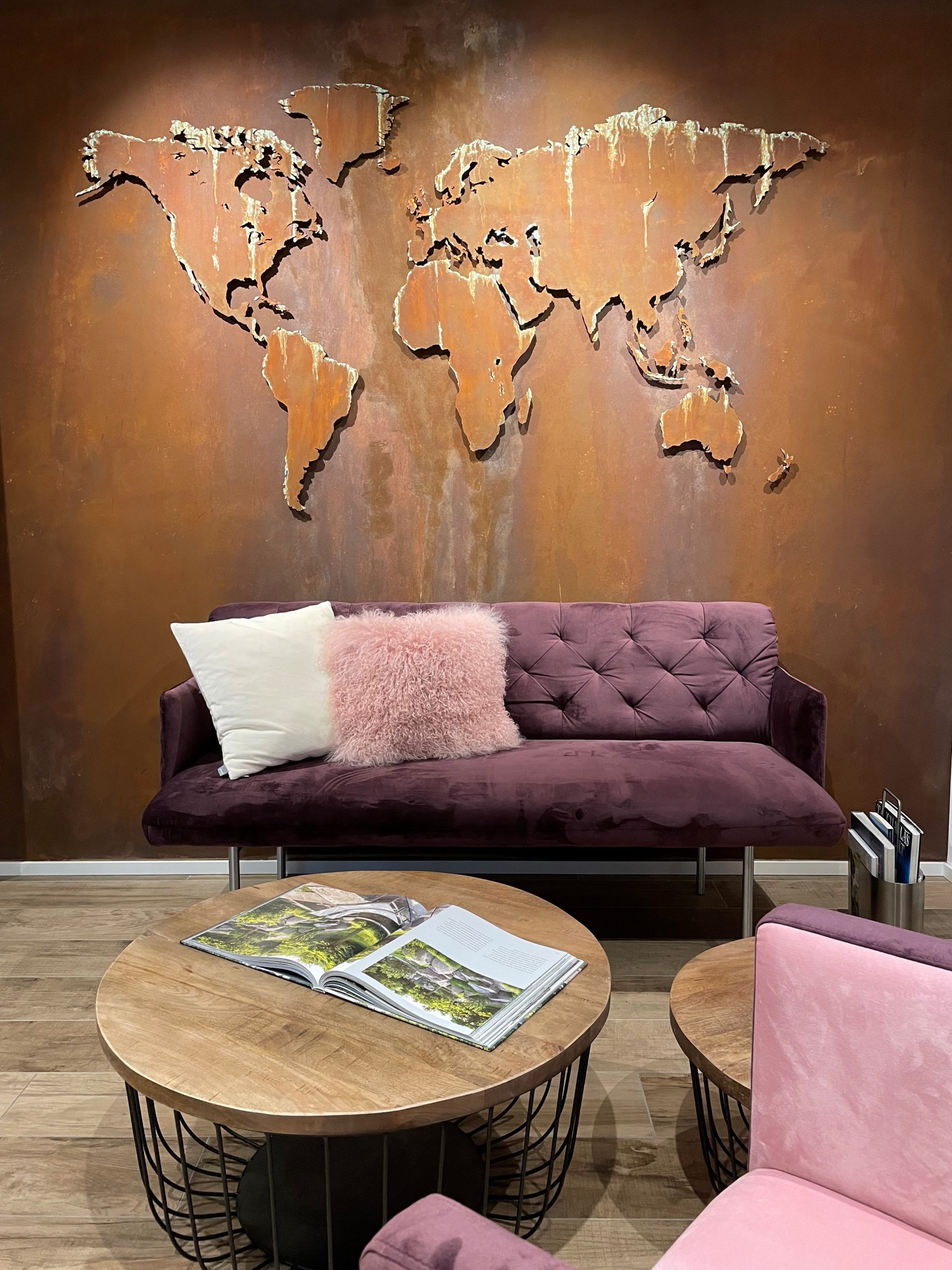 MapaWall world map Oak customized with rusty colors installed on a brown wall