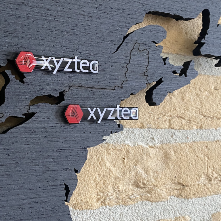 Custom pins XYZtec on a black magnetic world map