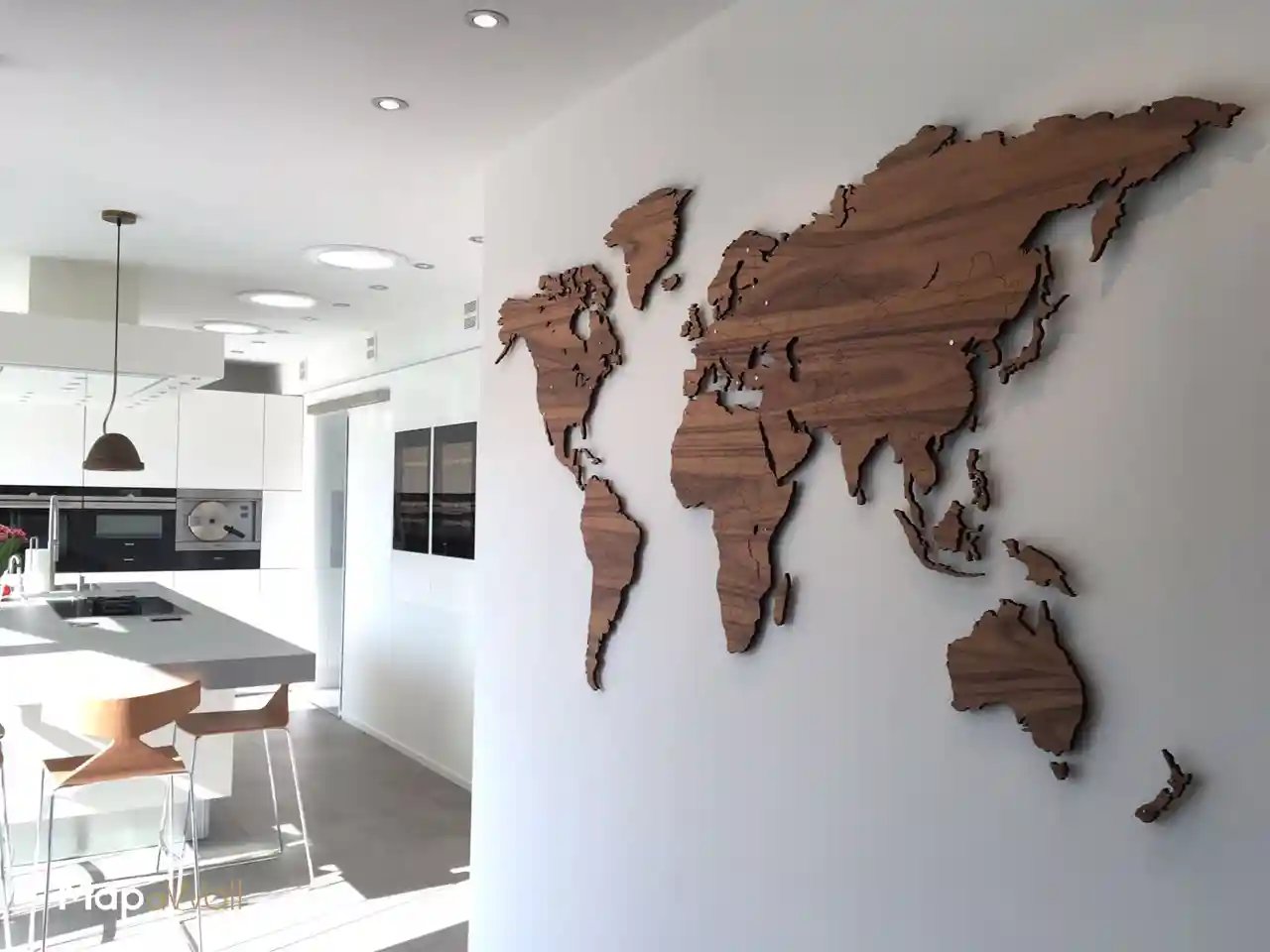 Our magnetic MapaWall Rosewood Santos world map with nickel plated pin-magnets installed in a modern and light kitchen